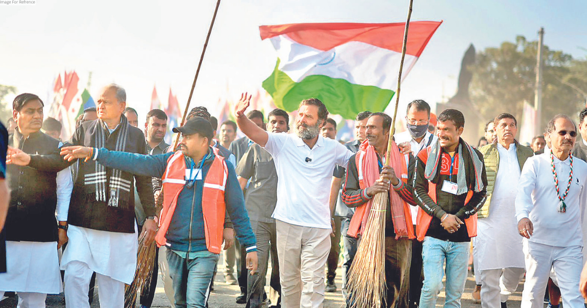 Rahul walks with arms around sanitation workers